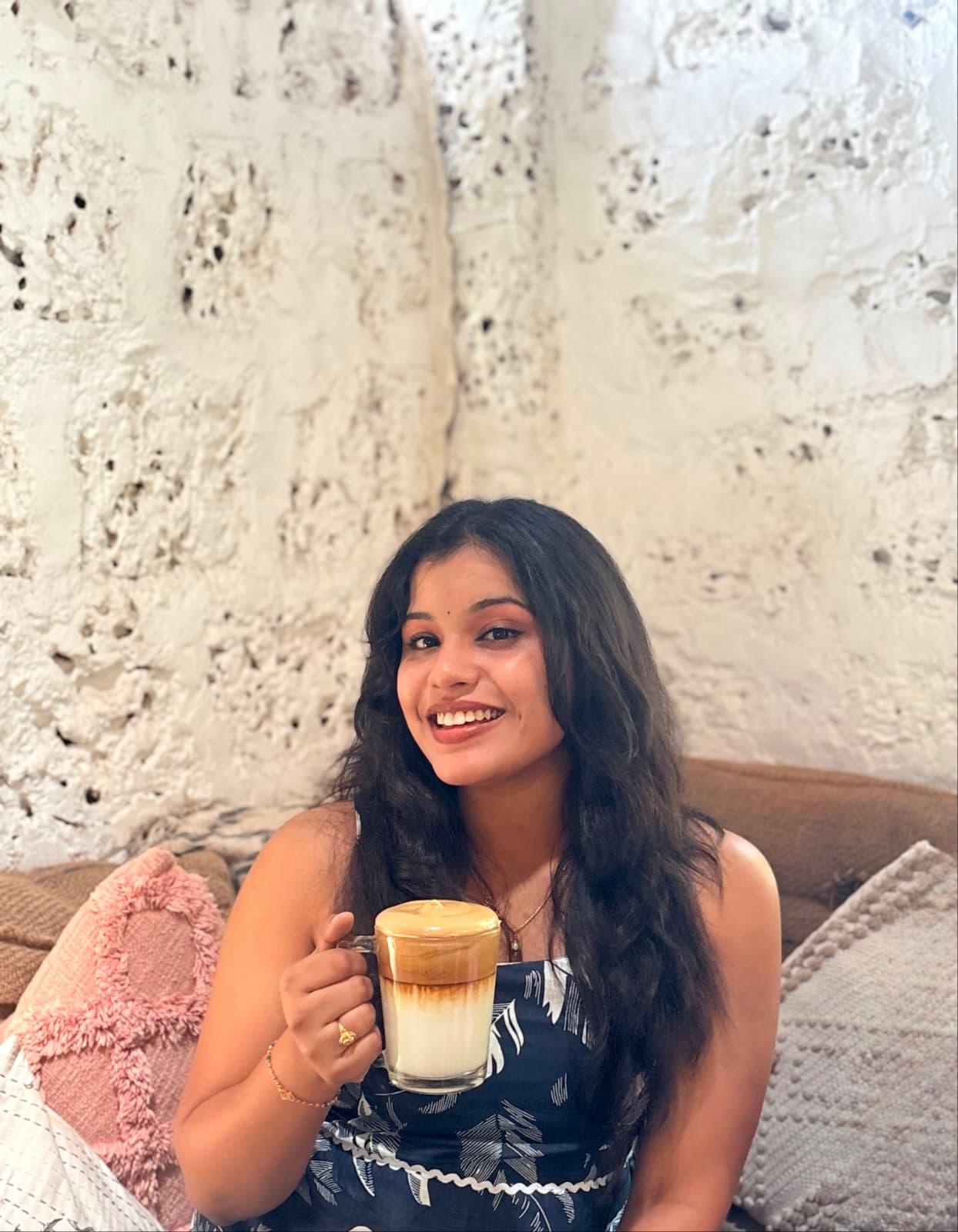 Sai Supriya smiling with a cup of coffee